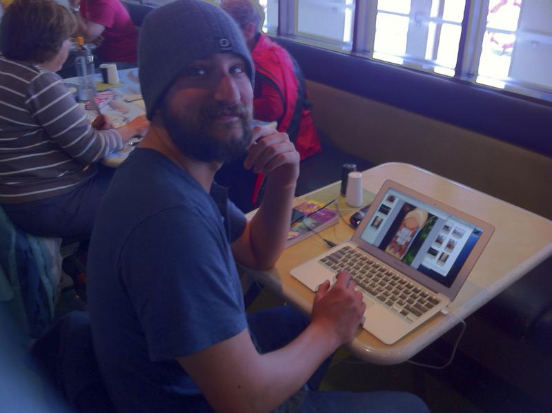 Gregg editing photos in the cafe. -- Alaska Marine Highway